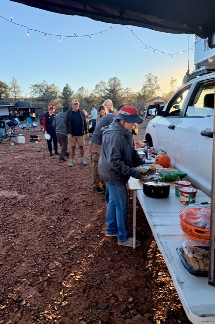The potluck line at the tailgate buffet