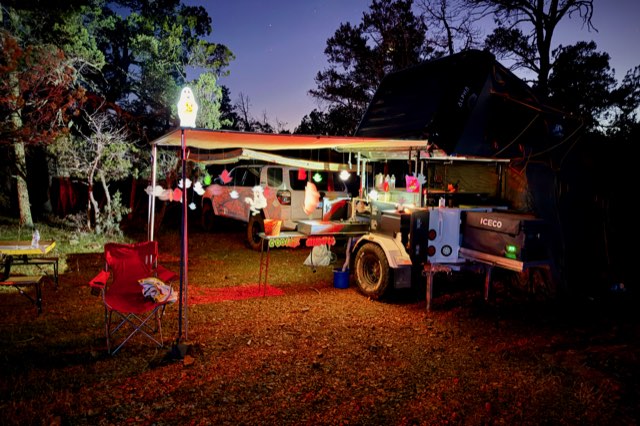 Camp in red light with lanterns