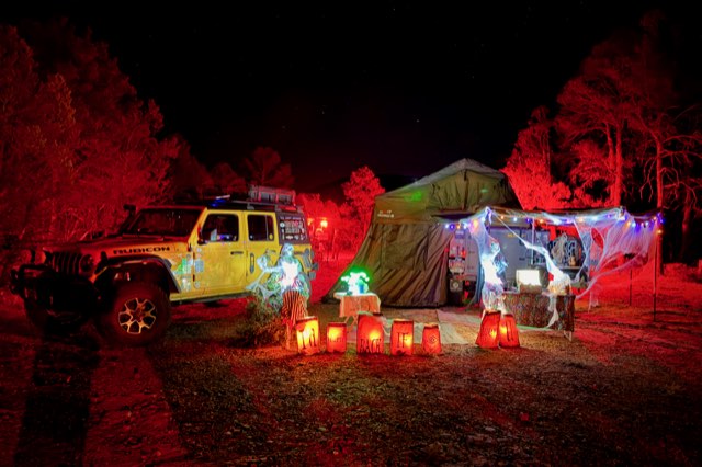 Camp strung with cobwebs and lights