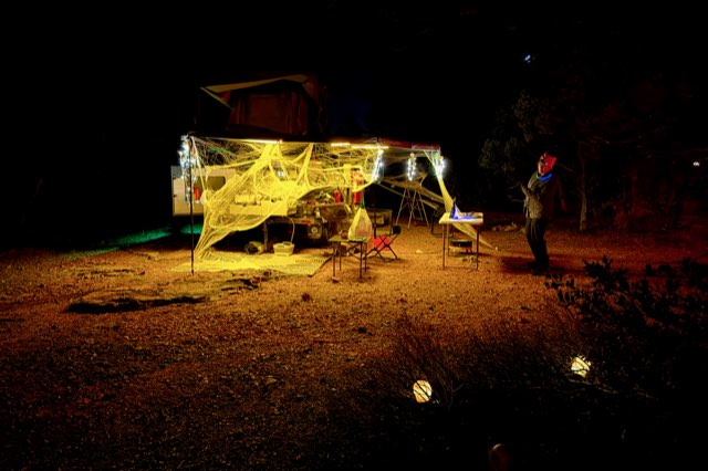Camp wrapped in glowing yellow webs